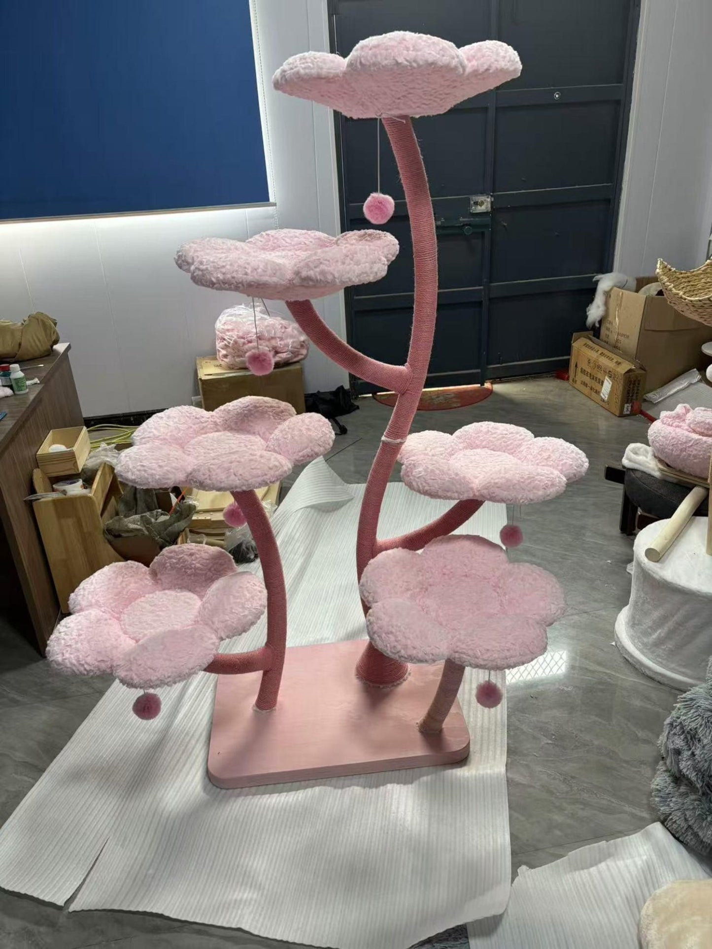 Alt-text: A tall flower-themed cat tree structure